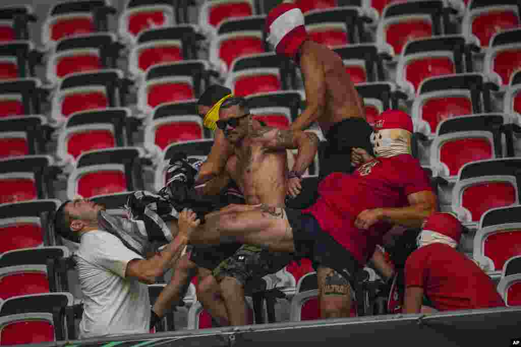 FC Koln supporters, right, fight with a Nice supporter prior the start of the Europa Conference League Group D match between Nice and FC Koln at the Allianz Riviera stadium in Nice, France.
