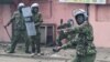 A Kenyan police officer throws a tear gas canister during anti-government protests in Nairobi on July 20, 2023.