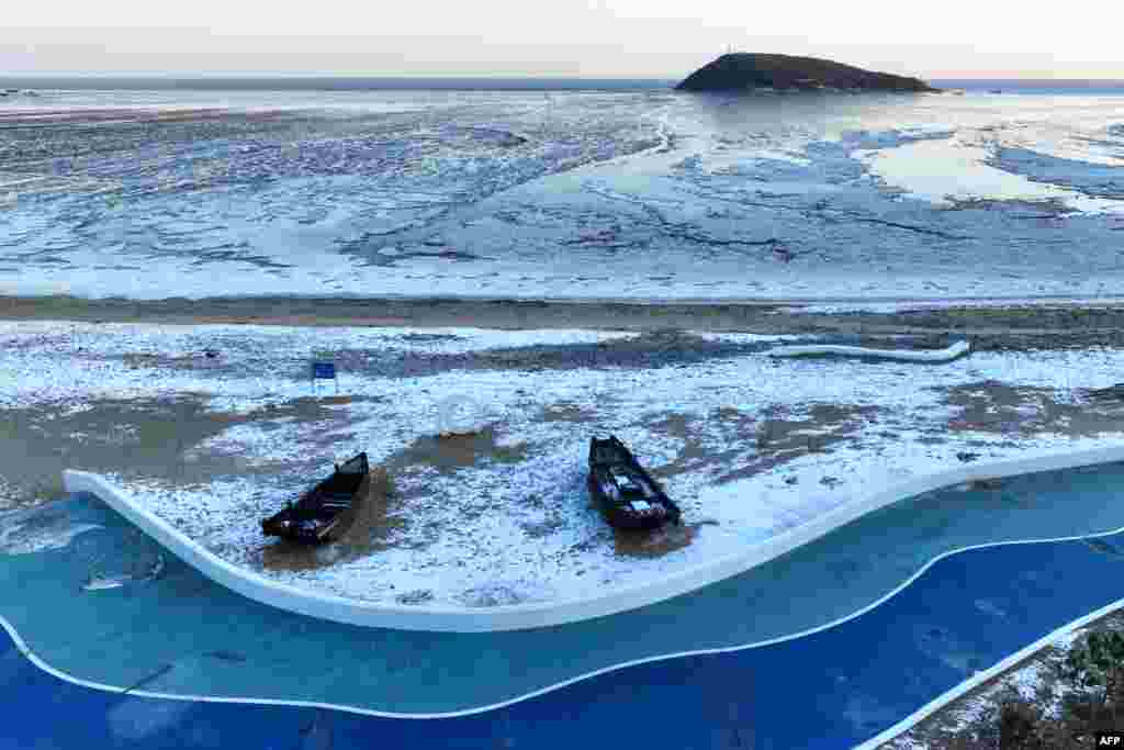 Fishing boats are seen being surrounded by sea ice in Lianyungang, in China's eastern Jiangsu province.