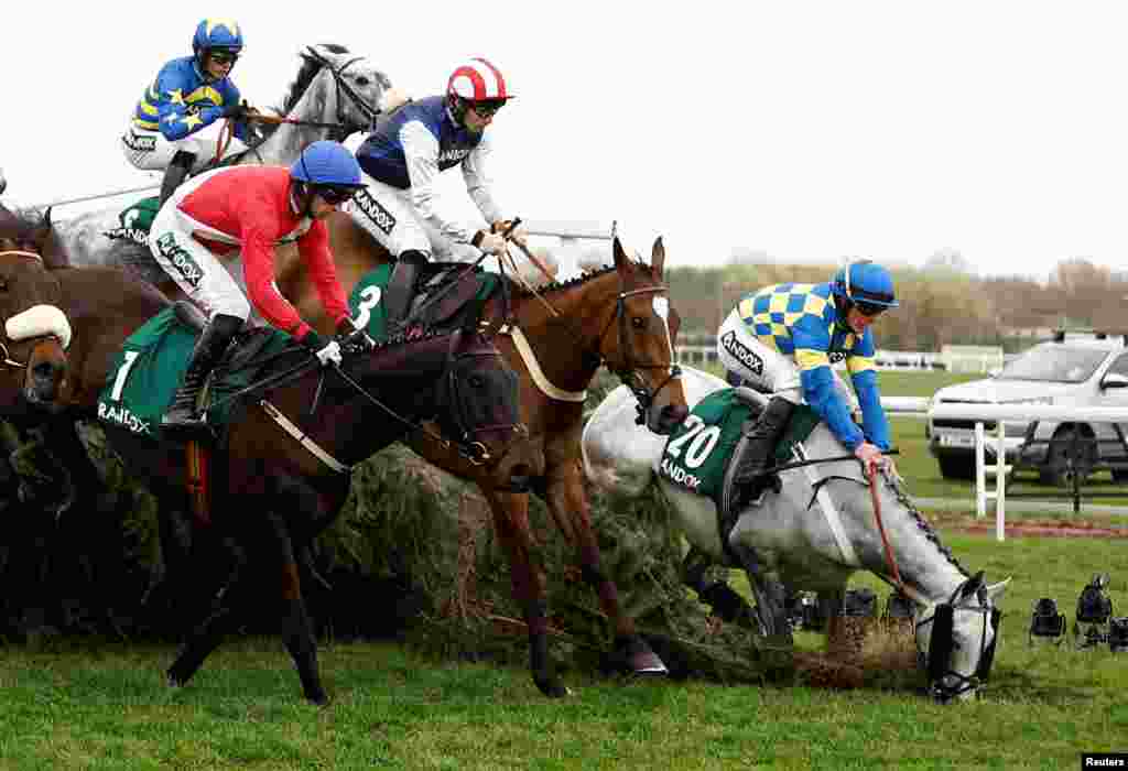 James Bowen, riding Bill Baxter, falls during a race at the Grand National Festival inside Aintree racecourse in Liverpool, Britain.