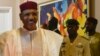 FILE - Niger President Mohamed Bazoum, left, at the presidential palace in Niamey, Niger, March 16, 2023. 
