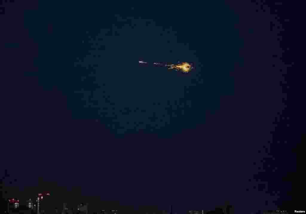 The explosion of a drone can be seen in the sky over the city during a Russian drone strike, in Kyiv, Ukraine.