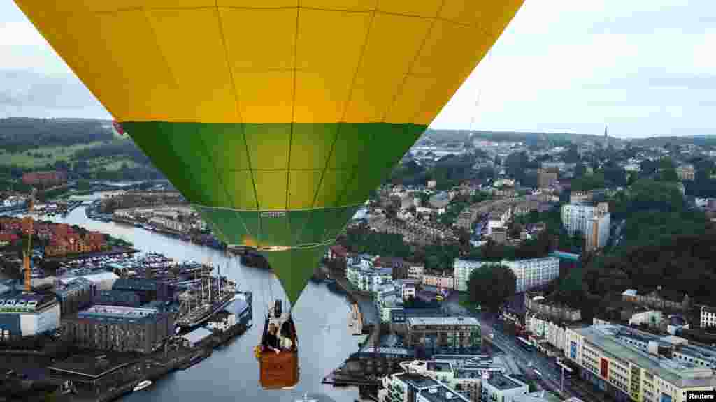 A hot air balloon flies during a mass launch at the annual Bristol International Balloon Fiesta, in Bristol, Britain.