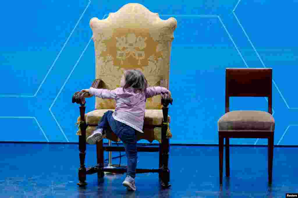 A child climbs Pope Francis' seat at "The General State of the Birth Rate" conference on Italy's sliding birthrate, in Rome, Italy.