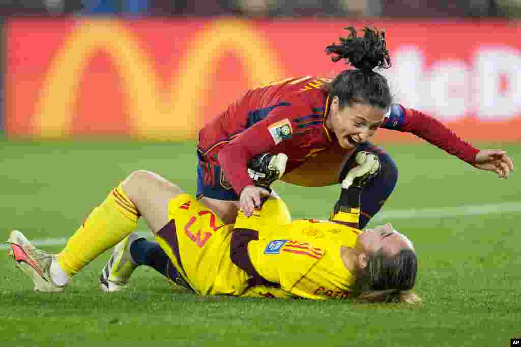 Spain's Ivana Andres celebrates with goalkeeper Cata Coll, on the ground, at the end of the Women's World Cup soccer final between Spain and England at Stadium Australia in Sydney, Australia. Spain won 1-0.
