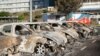 Burnt-out cars are seen in the parking lot of the old hospital on the outskirts of Noumea, French territory of New Caledonia, May 16, 2024. 