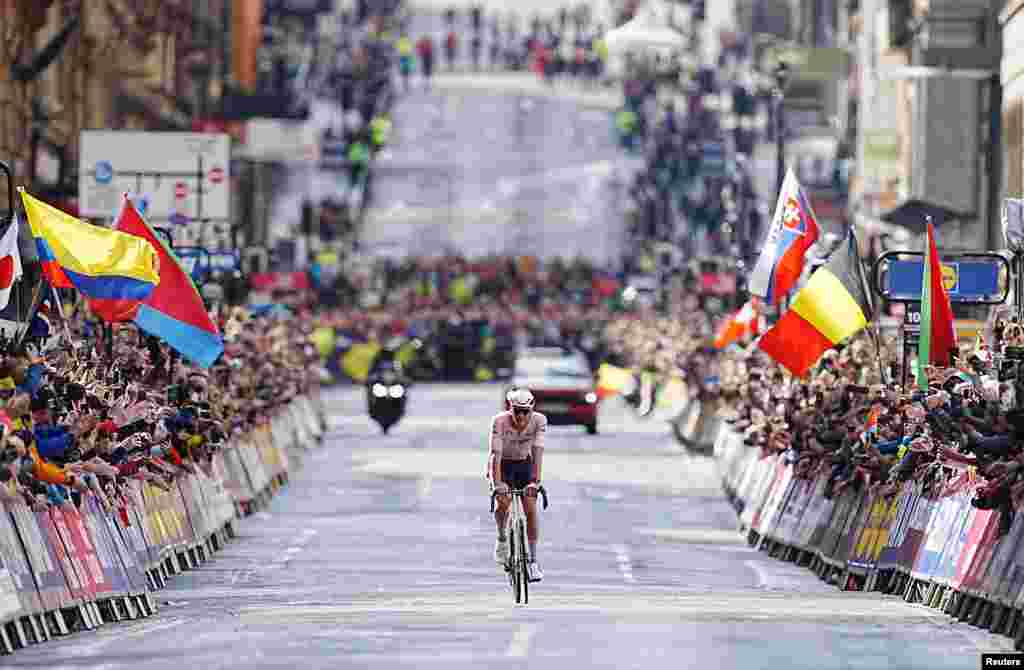 Netherlands' Mathieu van der Poel celebrates as he crosses the finish line to win the men's elite road race during the UCI World Championships 2023 in Glasgow, Scotland, Britain.