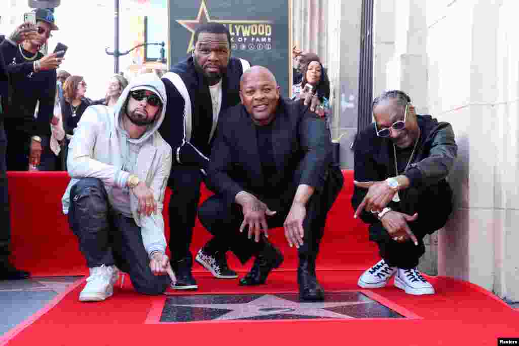 Eminem, Curtis "50 Cent" Jackson, and Snoop Dogg pose with Dr. Dre during the unveiling ceremony of his star on the Hollywood Walk of Fame in Los Angeles, California, March 19, 2024.