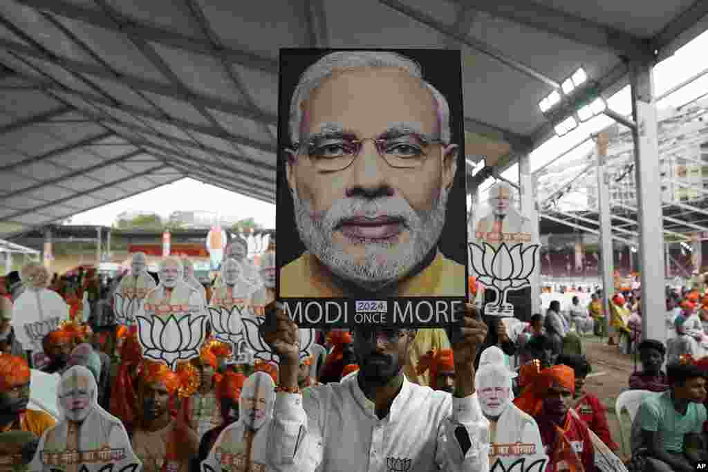 Bharatiya Janata Party (BJP) supporters carry portraits of Prime Minister Narendra Modi as they attend a public rally addressed by Modi in Hyderabad, India.