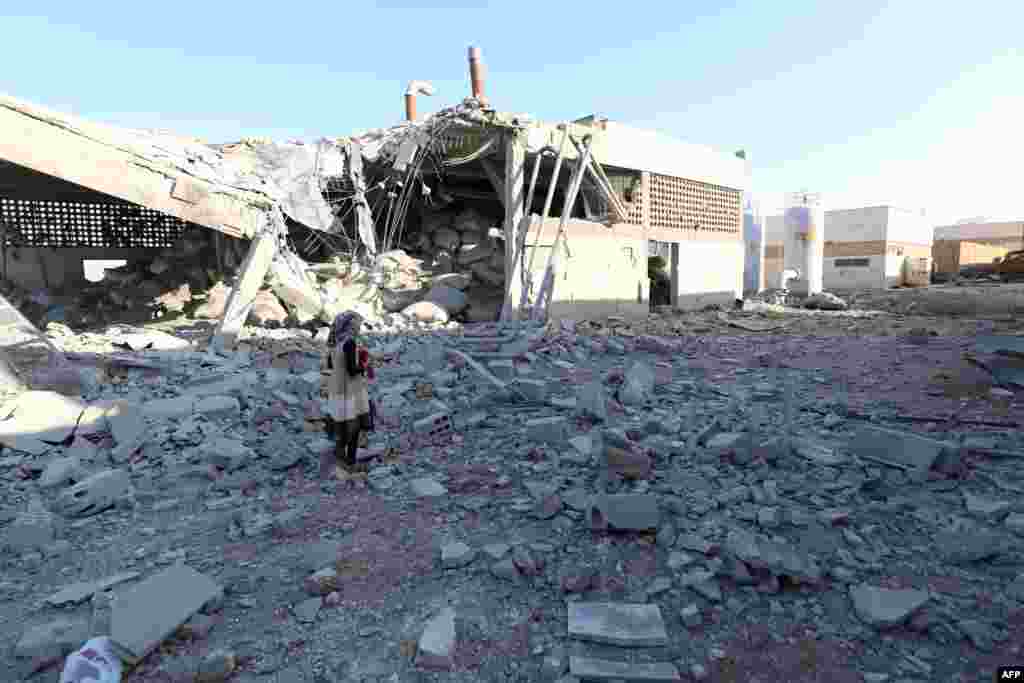 A girl stands amidst debris after at least two civilians were killed when Russian air strikes hit an abandoned water pumping station in Syria's rebel-held northwest.