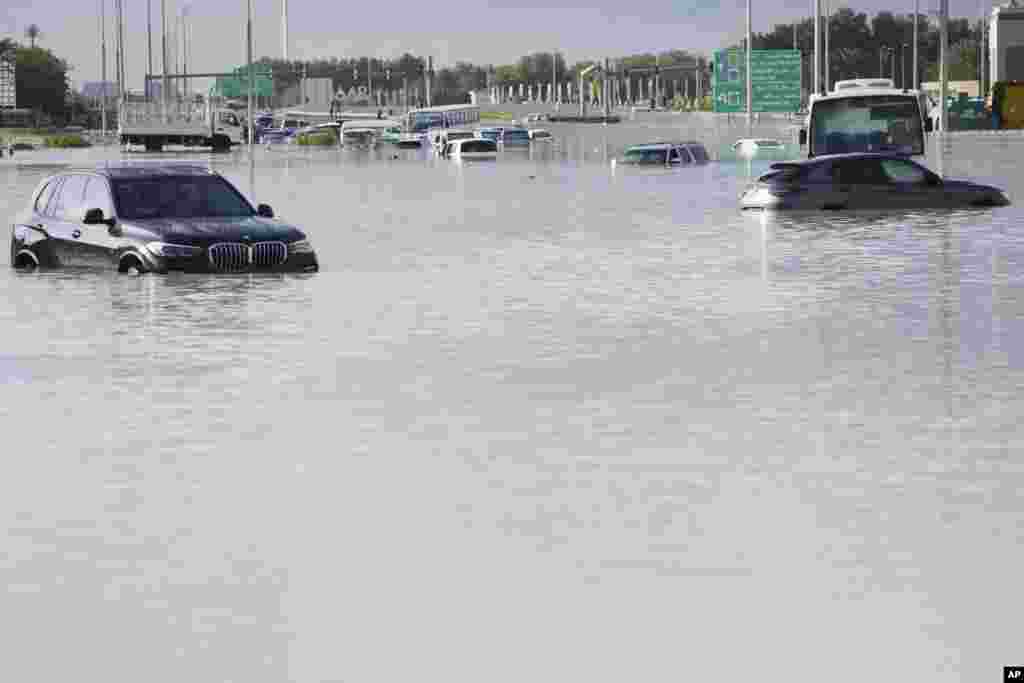 Vehicles sit abandoned in floodwater covering a major road in Dubai, United Arab Emirates. Heavy thunderstorms lashed the United Arab Emiratesy, dumping over a year and a half's worth of rain on the desert city-state of Dubai in the span of hours as it flooded out portions of major highways and its international airport. 