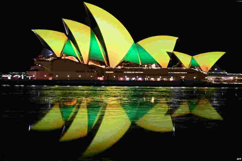 The Sydney Opera House is illuminated in green and gold in Sydney to support the Australia's women's football team ahead of their first World Cup knock-out round match against Denmark.