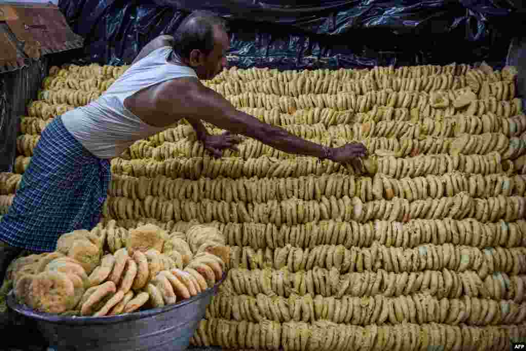 A worker arranges a traditional sweetmeat locally known as "Khaja" which are popularly sold ahead of Hindu festival of "Nag Panchami", at a workshop in Ahmedabad, India.