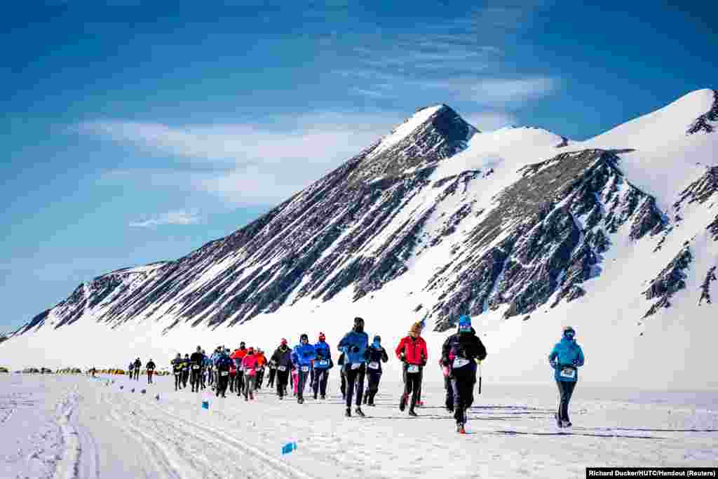 Runners participates in the Antarctic Ice Marathon at Union Glacier, Antarctica, Dec. 13, 2023.
