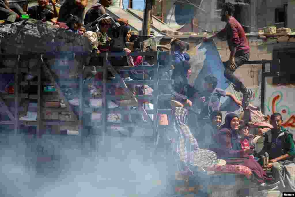 Palestinians flee Rafah in the southern Gaza Strip after Israeli forces launched a ground and air operation in the eastern part of the southern Gaza city.