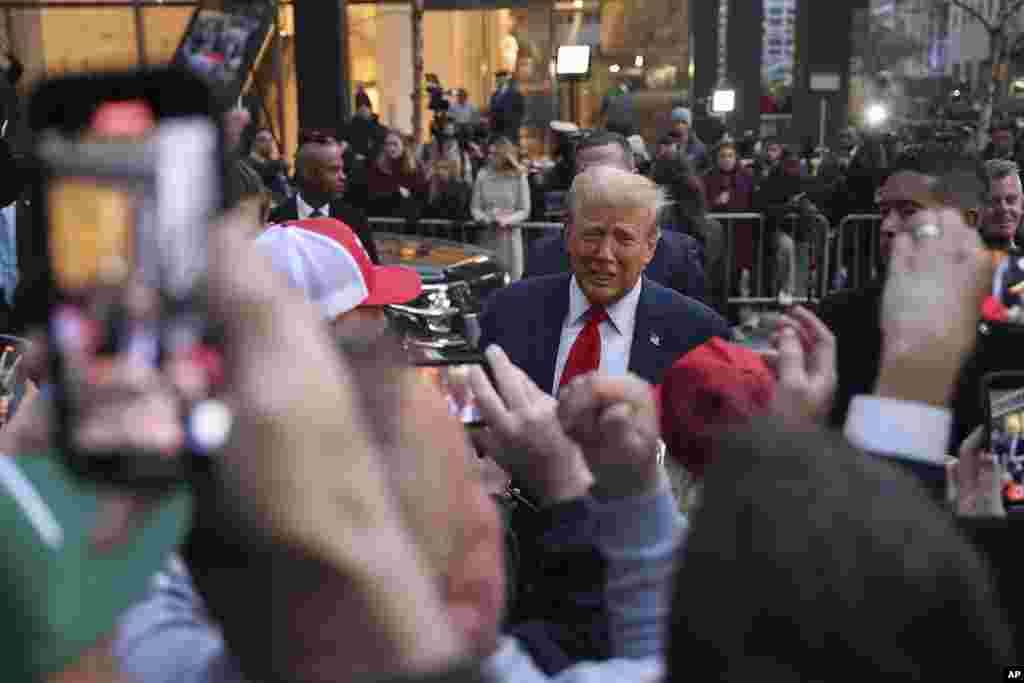 Former President Donald Trump signs autographs while speaking with construction workers at the construction site of the new JPMorgan Chase headquarters in midtown Manhattan in New York.
