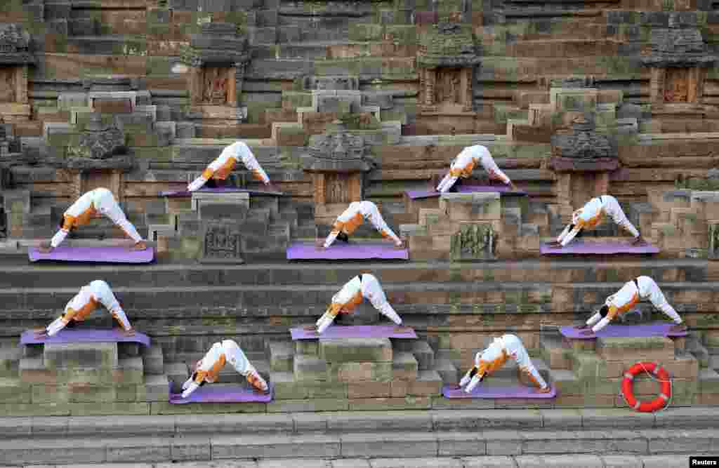 Participants perform a "Surya Namaskar" or sun salutation to welcome the new year at the Sun Temple in Modhera village near Ahmedabad, India.