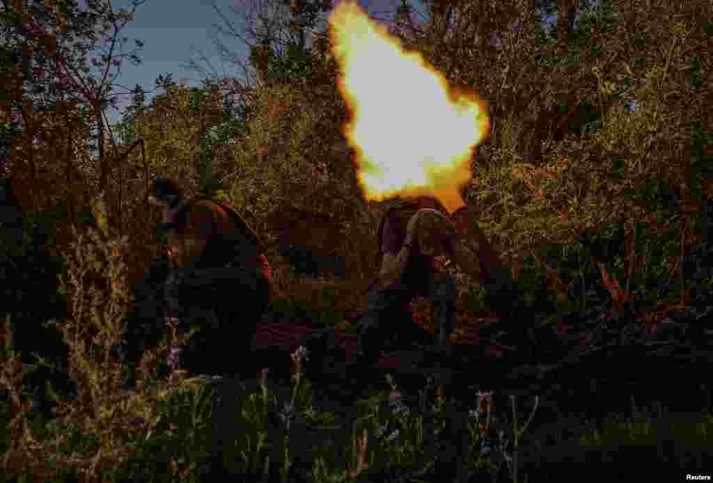 Ukrainian service members fire a mortar at a front line near the city of Bakhmut in Donetsk region. 