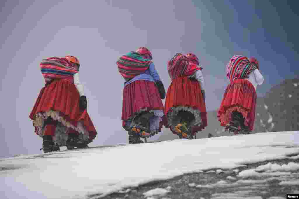 Elena Quispe Tincuta, 26, Julia Quispe Tincuta, 35, Alicia Quispe Tincuta, 40, and Pasesa Alana Llusco, 37, climb the snow-capped Huayna Potosi mountain, near El Alto, Bolivia. The cholita climbers's goal is to reach the summit of Everest in 2025.