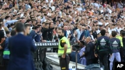 FILE - Real Madrid's Vinicius Junior, center, leaves the pitch after being shown a red card during a Spanish La Liga soccer match between Valencia and Real Madrid, at the Mestalla stadium in Valencia, Spain, May 21, 2023.