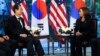 South Korea's Prime Minister Han Duck-soo, left, listens as U.S. Vice President Kamala Harris speaks during a bilateral meeting in Tokyo, Sept. 27, 2022.