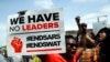 FILE - People hold banners as they protest against police brutality at Lekki toll gate in Lagos, Nigeria, Oct. 15, 2020. Protests started in Lagos against a police unit known as the Special Anti-Robbery Squad, or SARS, which faced widespread accusations of brutality.