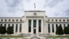 FILE - An American flag flies over the Federal Reserve building in Washington, May 4, 2021. A report issued July 26, 2022, by Senate Republicans alleges that China is trying to infiltrate the Federal Reserve. 