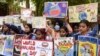 Students hold placards during an event to mark the World Malaria Day at a government hospital on the outskirts of Amritsar in India on April 25, 2022. 