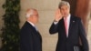 U.S. Secretary of State John Kerry (R) waves as he stands next to Palestinian Chief Negotiator Saeb Erekat before his meeting with Palestinian President Mahmoud Abbas in the West Bank city of Ramallah May 23, 2013.