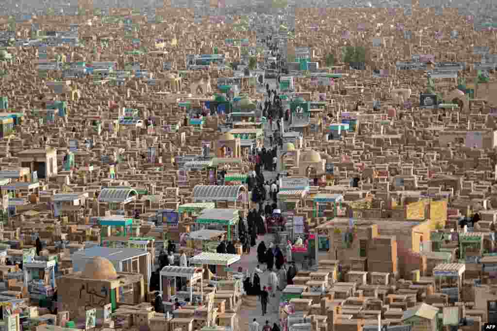 Muslims visit the graves of their relatives at the Wadi al-Salam (Valley of Peace) cemetery in Iraq's holy city of Najaf during Eid al-Fitr holiday, which marks the end of the holy fasting month of Ramadan, May 3, 2022.
