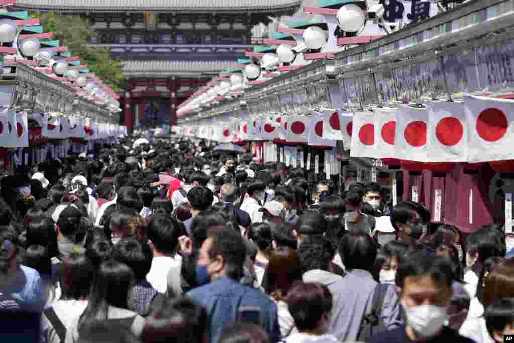 Holidaymakers wearing face masks visit Asakusa Sensoji Buddhist temple in Tokyo, Japan, during the Golden Week holidays.