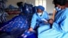 Para petugas tengah bekerja di pabrik pembalut yang dapat digunakan kembali di Bonda Women Craft Centre, di distrik Mutasa, di Mutare, Zimbabwe, 13 Juli 2022. (REUTERS/Philimon Bulawayo)