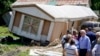 President Joe Biden tours a neighborhood impacted by flooding, in Lost Creek, Kentucky, Aug. 8, 2022. 