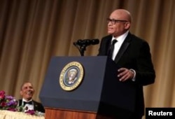 U.S. President Barack Obama, left, listens to comedian Larry Wilmore at the White House Correspondents' Association annual dinner in Washington, April 30, 2016.