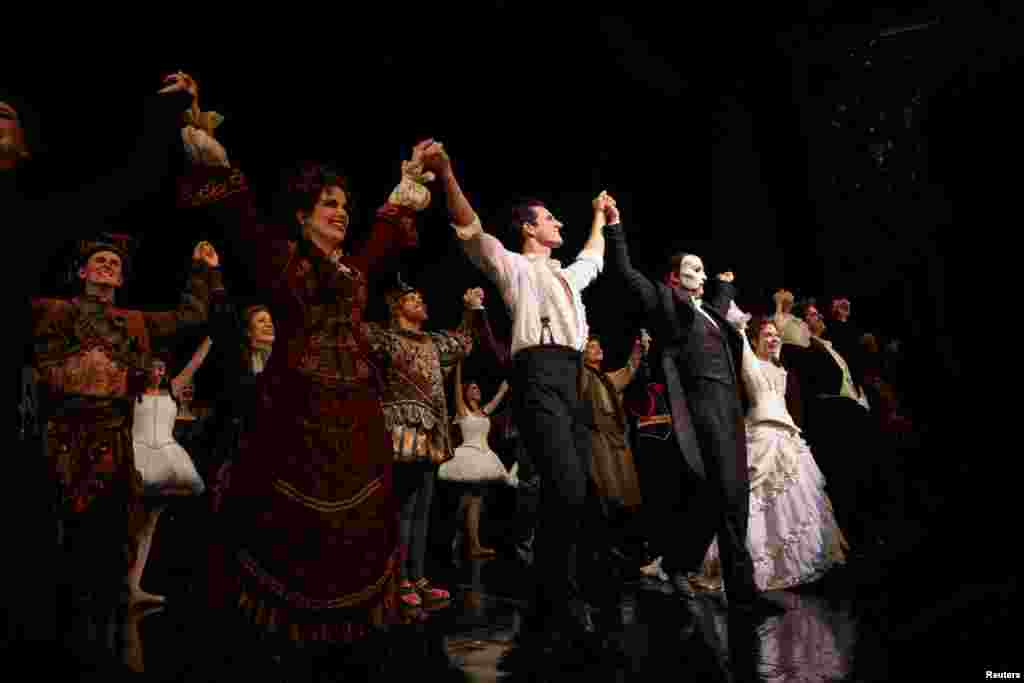Cast members stand on the stage after performing on the re-opening night of "Phantom of the Opera" at the Majestic Theater in New York City, New York, Oct. 22, 2021.