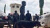 Officers stand guard outside the Kuje maximum prison following a rebel attack in Kuje, Nigeria, July 6, 2022. 