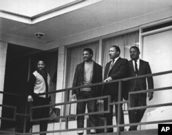 FILE - The Rev. Martin Luther King Jr. stands with other civil rights leaders on the balcony of the Lorraine Motel in Memphis, Tenn., a day before he was assassinated at approximately the same place, April 3, 1968.