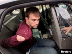 Travis Reinking, the suspect in a Waffle House shooting in Nashville, is under arrest by Metro Nashville Police Department in a wooded area in Antioch, Tennessee, April 23, 2018.