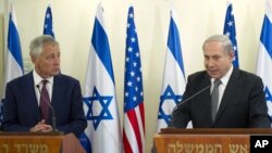 U.S. Secretary of Defense Chuck Hagel, left, listens at a joint press conference with Israeli Prime Minister Benjamin Netanyahu at the latter's office in Jerusalem, April 23, 2013.