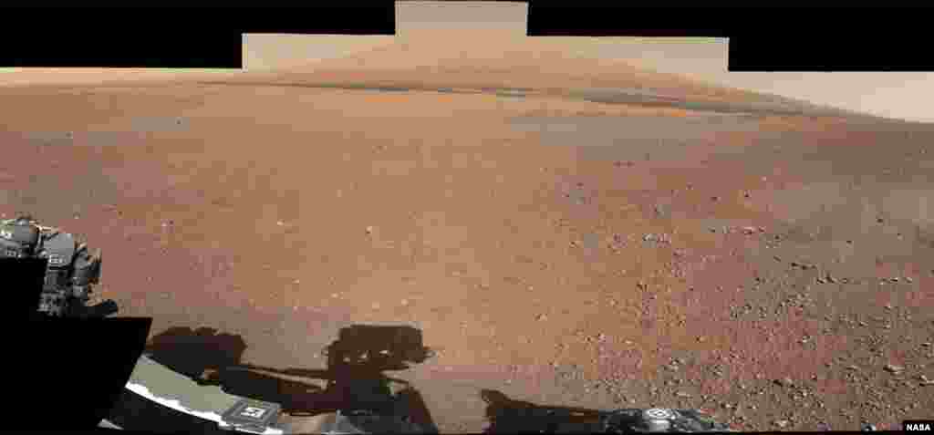 This color panorama shows a 360-degree view of the landing site of NASA's Curiosity rover, including the highest part of Mount Sharp visible to the rover. That part of Mount Sharp is approximately 12 miles (20 km) away from the rover.