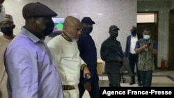 The Nigeria State Secret Police escort separatist leader Nnamdi Kanu, second from left, outside the Federal High Court in Abuja, Nigeria, Oct. 21, 2021. 