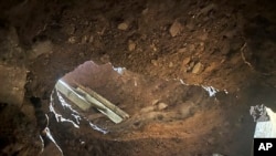 This Dec. 9, 2019 photo provided by U.S. Customs and Border Protection (CBP) shows an access point to a tunnel between Nogales, Mexico, and Nogales, Ariz., seen from the U.S. side. 