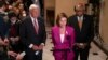 House Speaker Nancy Pelosi, center, with Majority Leader Steny Hoyer, left, and Majority Whip James Clyburn updates reporters after delays in the vote to advance President Joe Biden's domestic policy package, at the Capitol in Washington, Nov. 5, 2021.