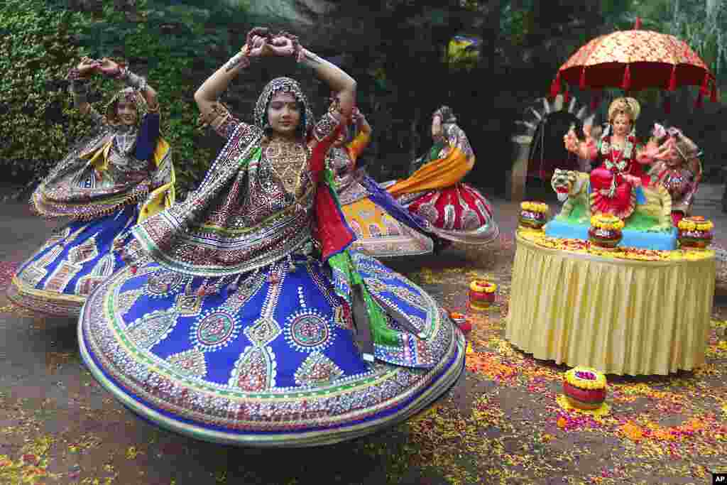 Indian women in traditional attire practice Garba, a traditional dance of Gujarat state, ahead of Hindu festival of Navratri in Ahmadabad, India.