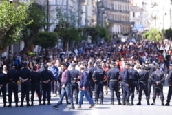 FILE - Demonstrators march in support for the Hirak pro-democracy movement., in Algiers, May 7, 2021.