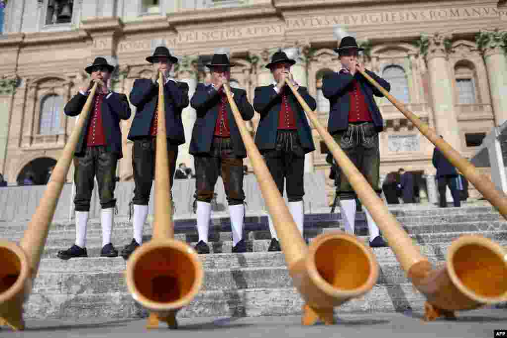 Bavarian musicians from Engetried play traditional horns in St. Peter's Square before the pope's weekly general audience at the Vatican.