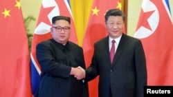 中国领导人习近平在北京接见到访的朝鲜领导人金正恩。 （2018年6月20日）