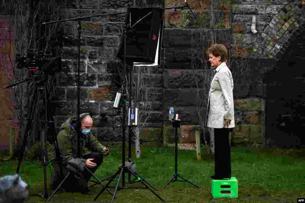 Scotland's First Minister and leader of the Scottish National Party (SNP), Nicola Sturgeon, waits for the camera technician as she launches the SNP virtual electoral campaign in Partick in the West End of Glasgow.