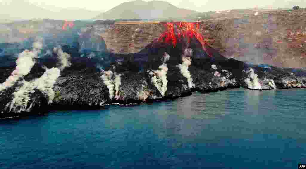 This image grab taken from a video provided by the Spanish Institute of Oceanography (IEO-CSIC) shows an aerial shot from the oceanographic vessel Ramon Margalef (IEO) of the delta formed on the coast from the lava of the Cumbre Vieja volcano, on the Canary Island of La Palma.