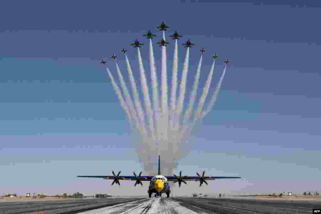 This handout photo of the U.S. Air Force shows the U.S Air Force Air Demonstration Squadron "Thunderbirds" and the U.S. Navy Flight Demonstration Squadron "the Blue Angels" debut the Super Delta formation over a C-130J Super Hercules at Naval Air Facility El Centro, March 2, 2021. 